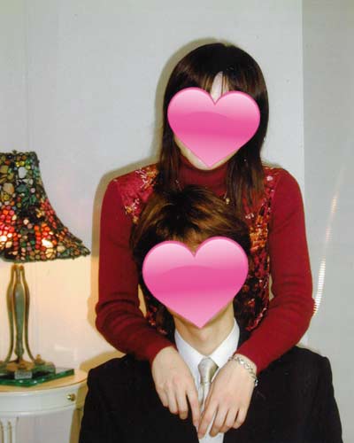 結婚相談所で出会い成婚した夫婦の写真。座る男性の首元に女性が両腕を回し、幸せそうに寄り添っている様子