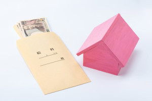 家賃支払いのイメージ（給料袋と家の模型）